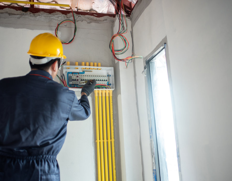 Electricians repairing breaker panel