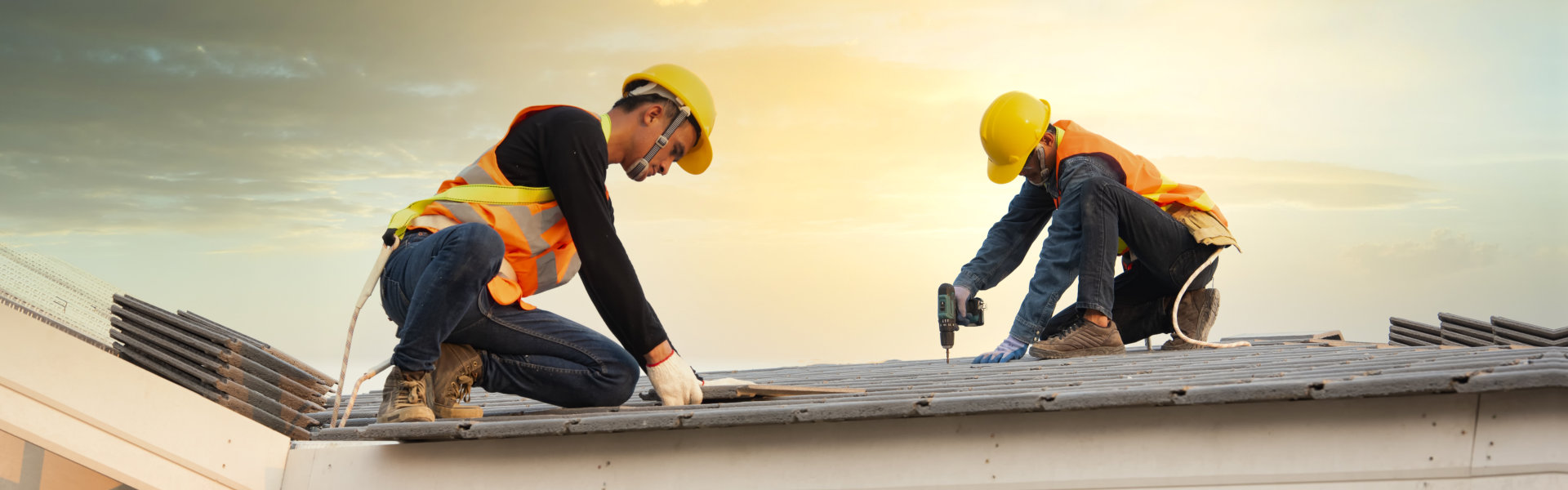workers installing new roof